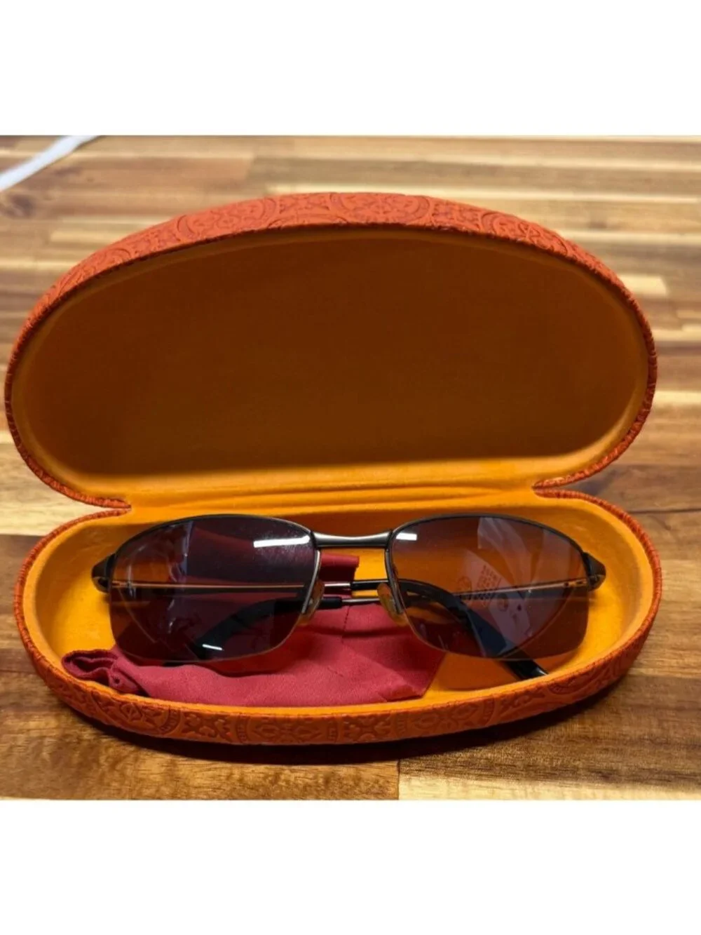 Nice pair of sunglasses with hard embossed case, cleaning cloth
